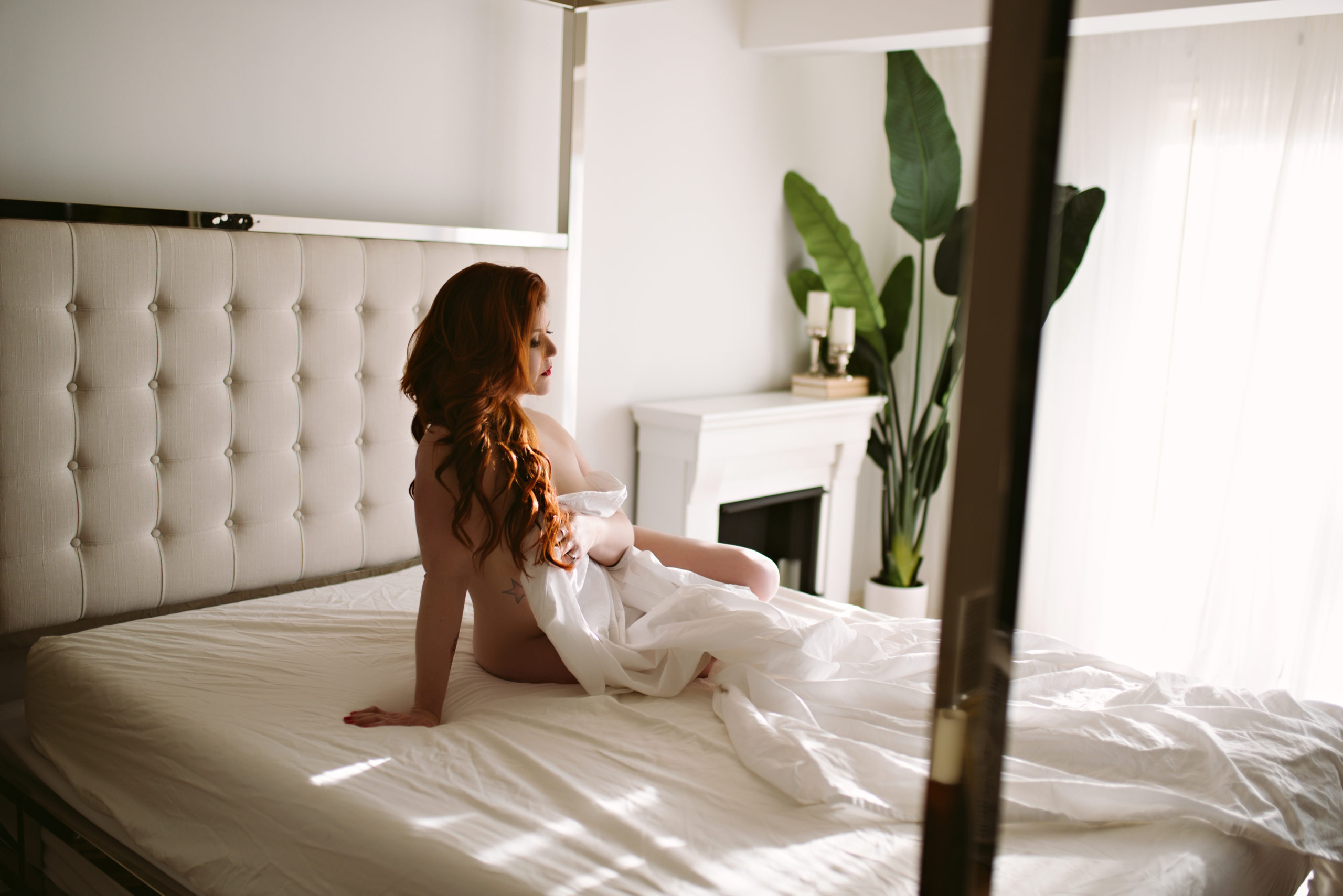 woman on bed in white sheet