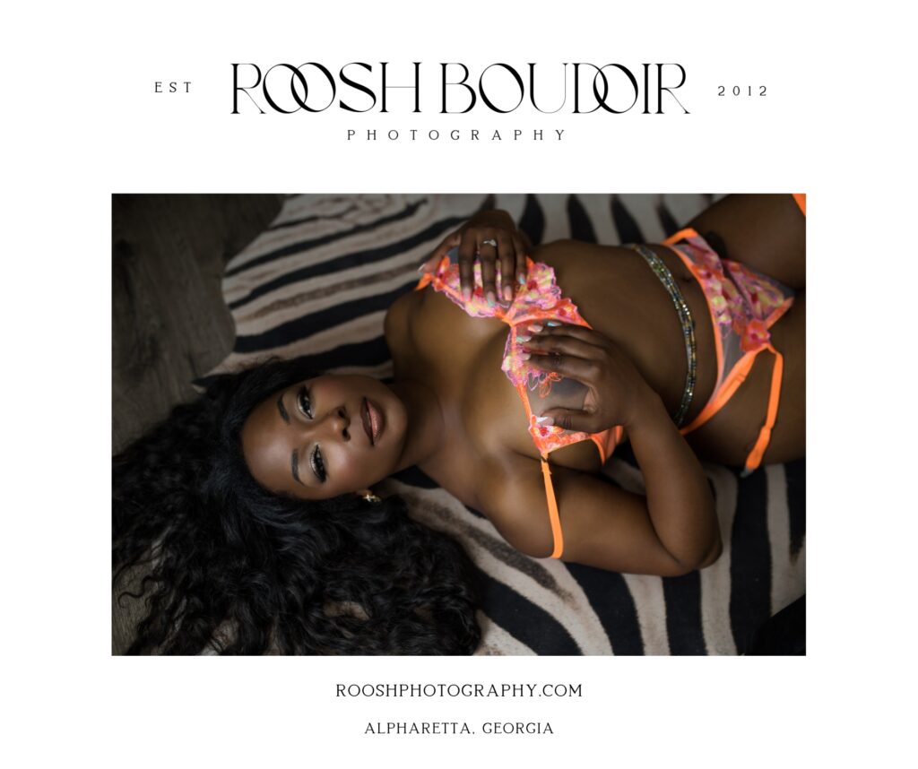 african american woman laying on the floor in orange floral lingerie in boudoir photo shoot pose